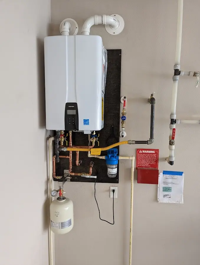 Professional plumber installing copper piping in a Chestertown home